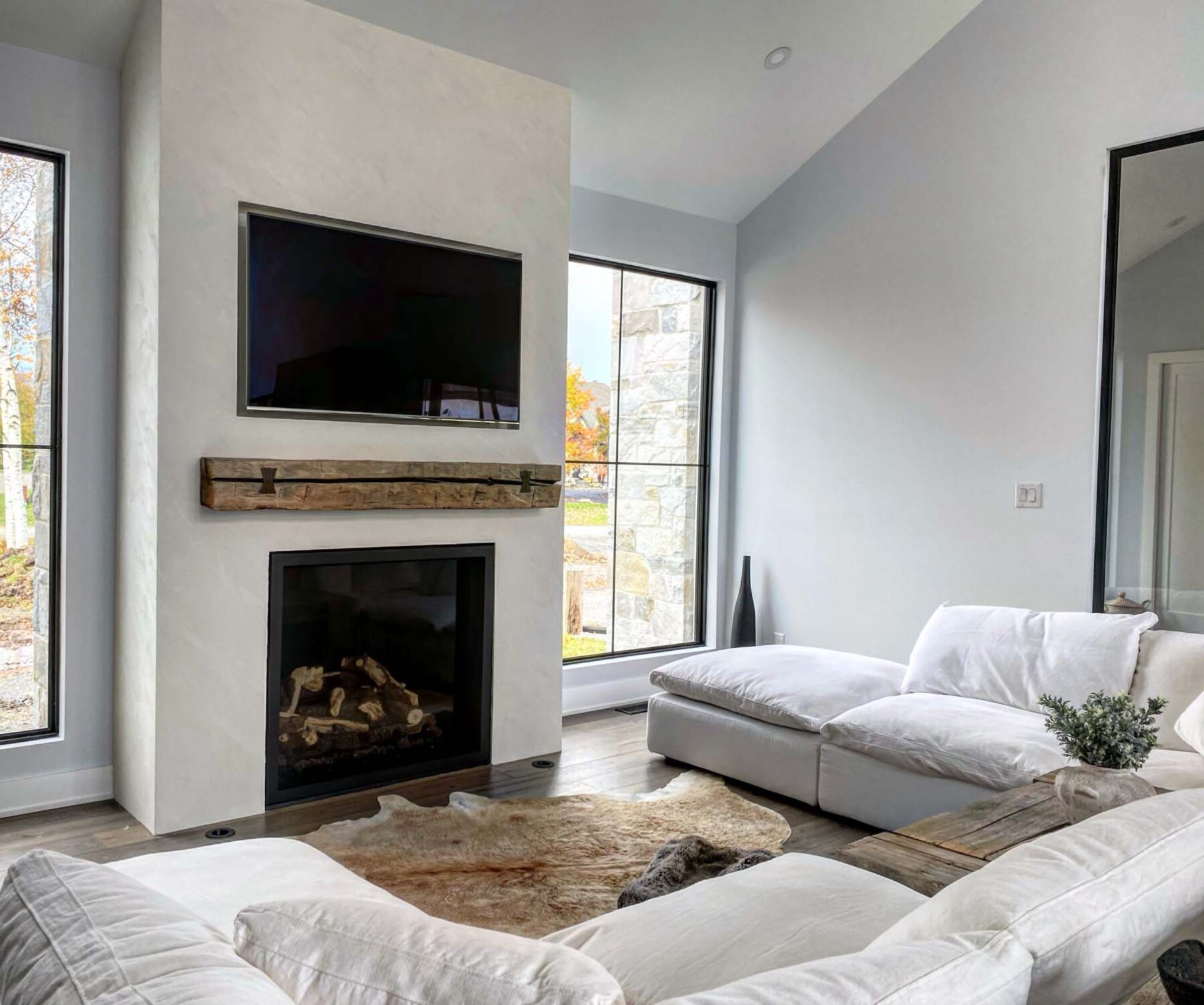 Greige matte stone finish plaster around a fireplace, Ottawa