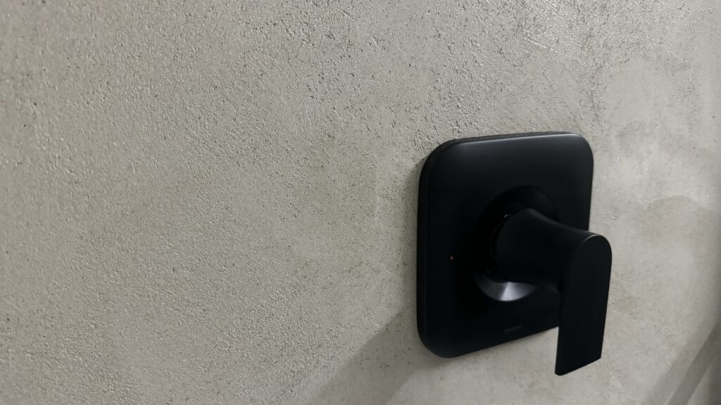 Close-up of sealed microcement concrete texture with black fixture