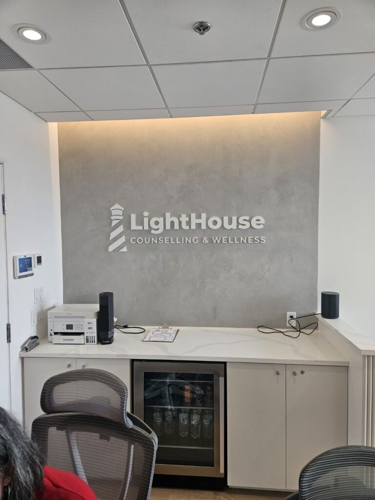 Grey concrete effect lobby feature wall with dimensional lettering, Ottawa