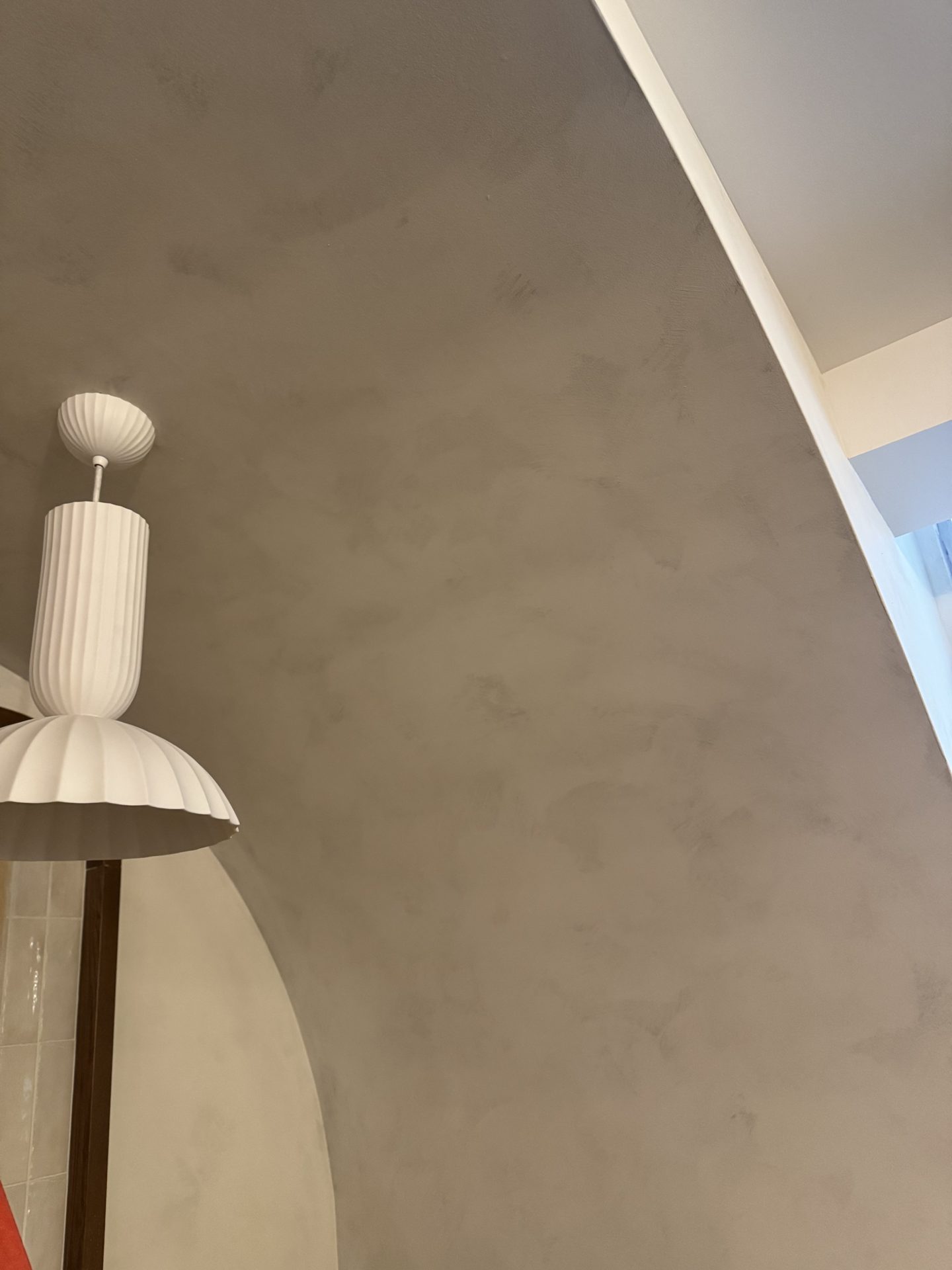Warm greige limewash wall with curved archway, Ottawa