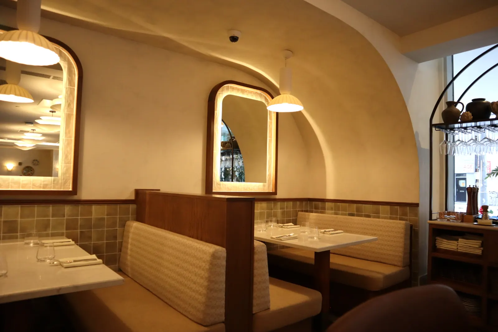 Smooth light limewash dining room with arched mirrors at Carletto, Metcalfe Hotel Ottawa