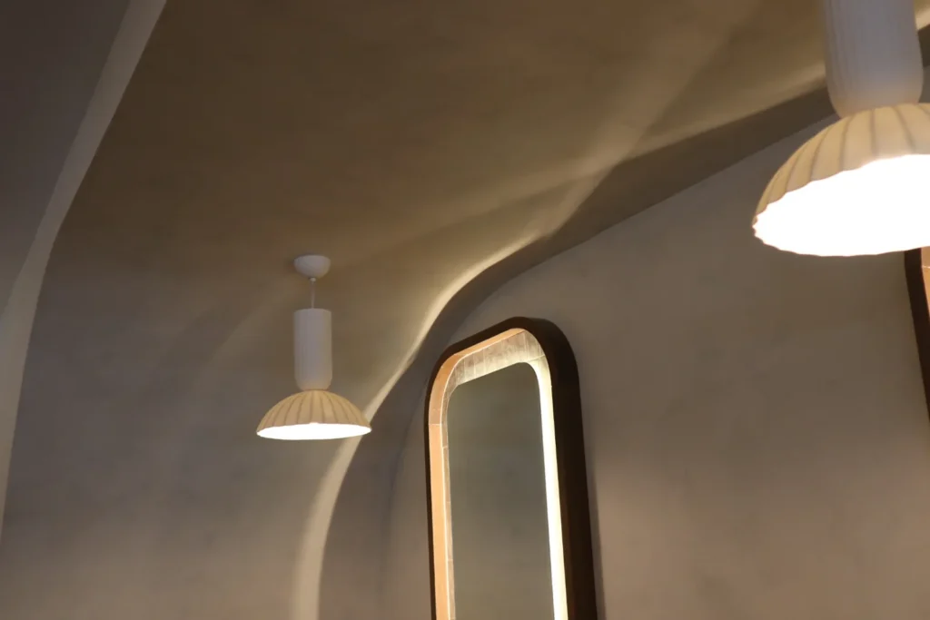 Limewash across barrel-arched ceiling coves with pendant lights, Ottawa restaurant