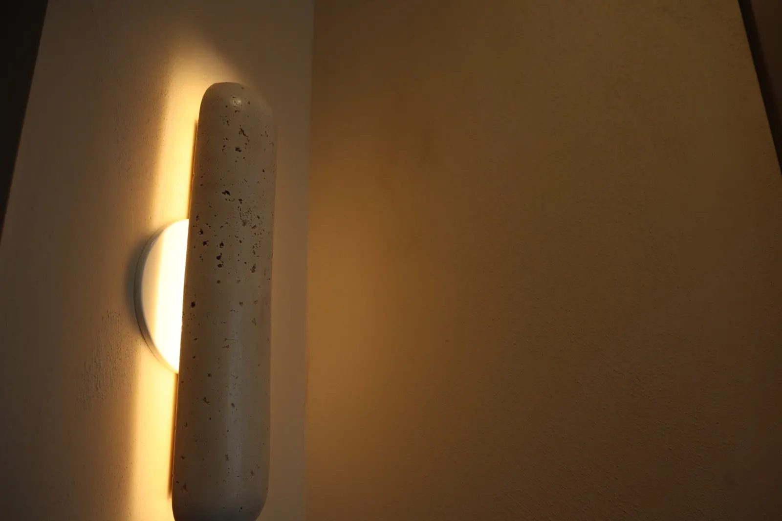 Close-up of limewash texture under a wall sconce in Ottawa