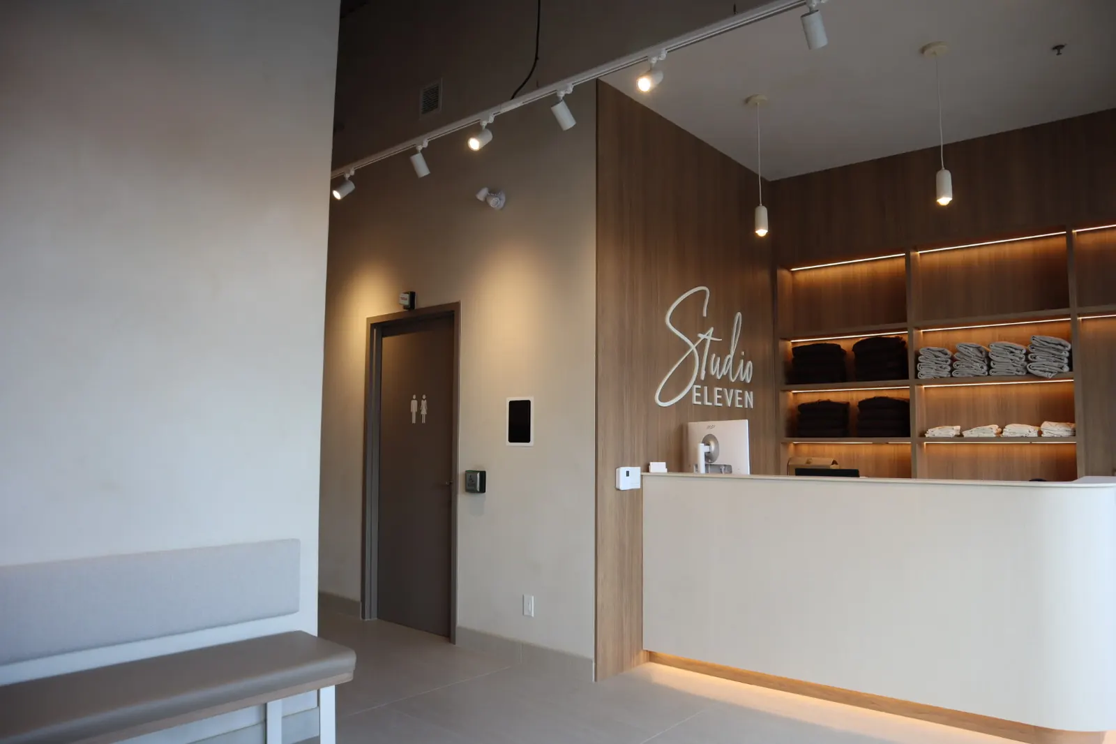Limewash walls and microcement reception desk in the entry of an Ottawa pilates studio