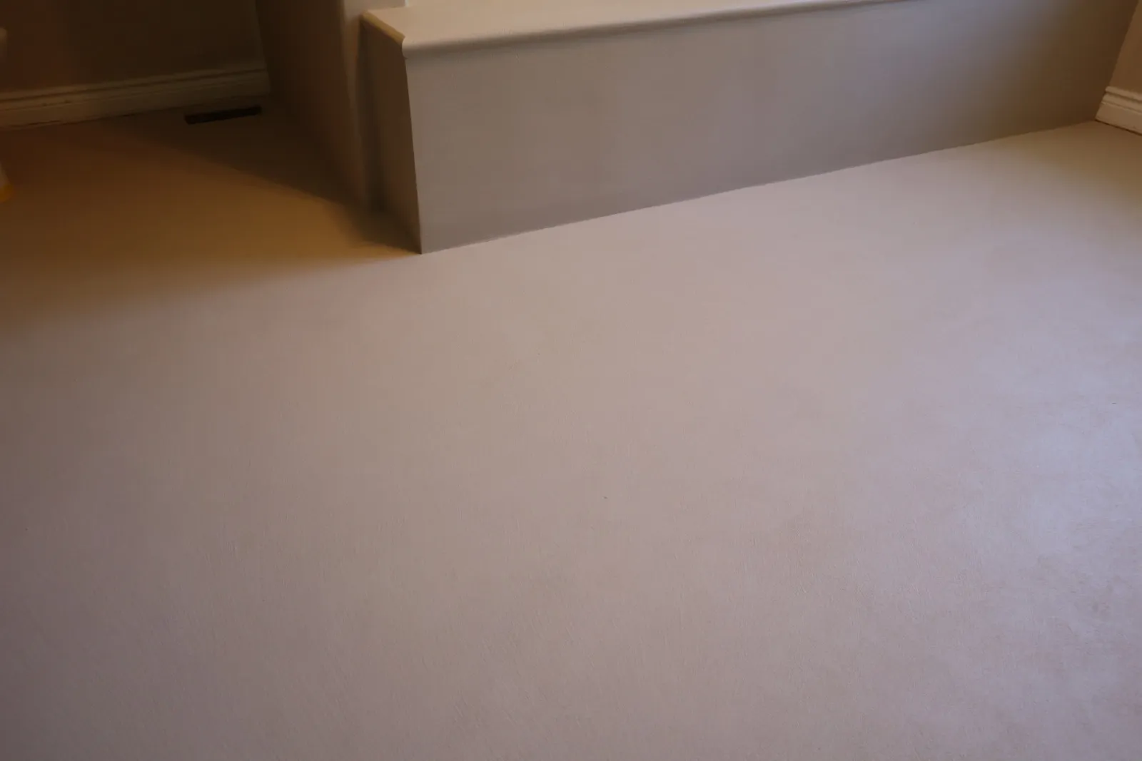 Close-up of hand-troweled microcement bathroom floor texture with no grout lines in Ottawa
