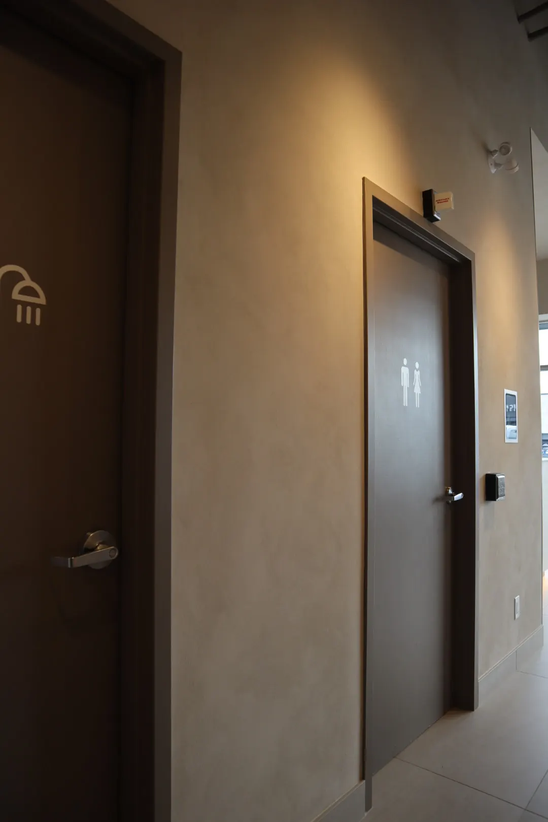 Sandy limewash hallway and change room door at a commercial fitness studio in Ottawa