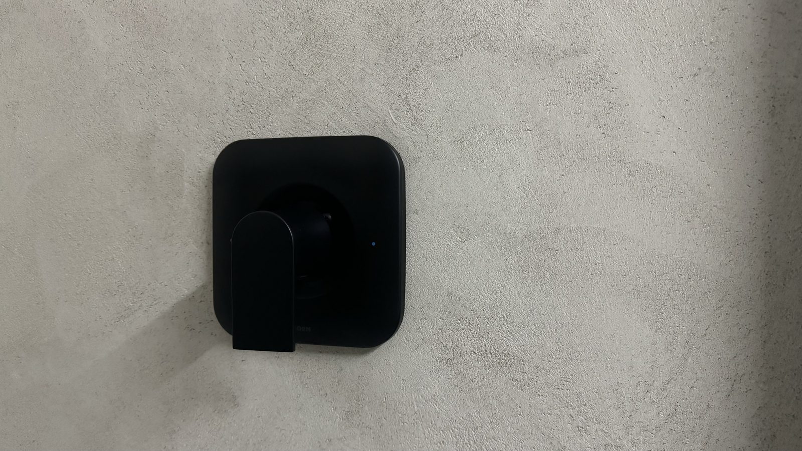 Stone effect plaster finish applied to interior wall surface showing textured gray-brown coloring and dimensional depth